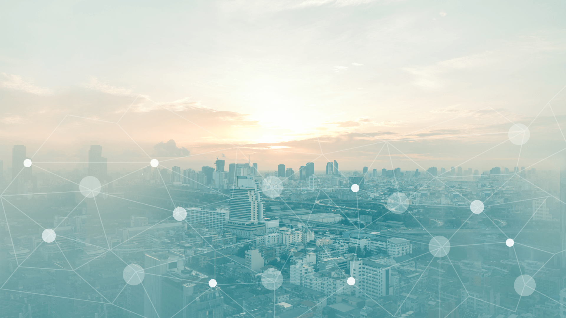 City skyline at sunset with a network overlay featuring interconnected nodes and lines.