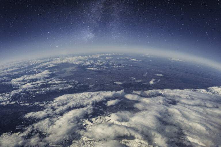 Aerial view of Earth showcasing clouds and landmasses from a space perspective.